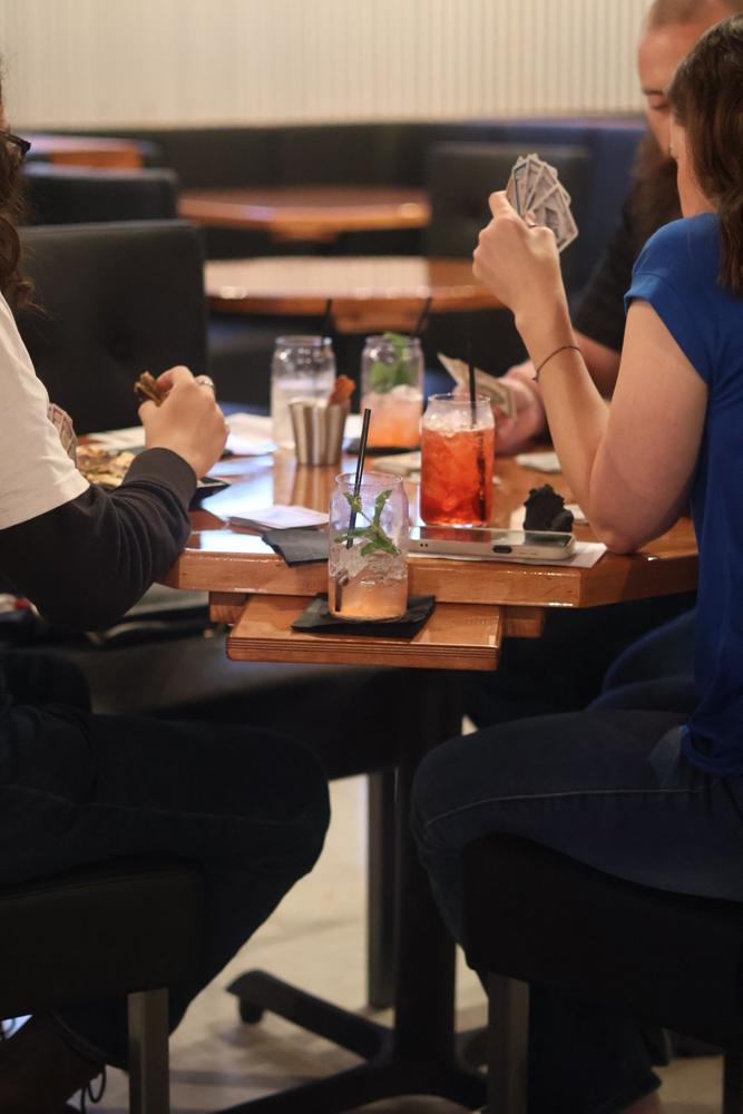 Guests playing cards in the dining room