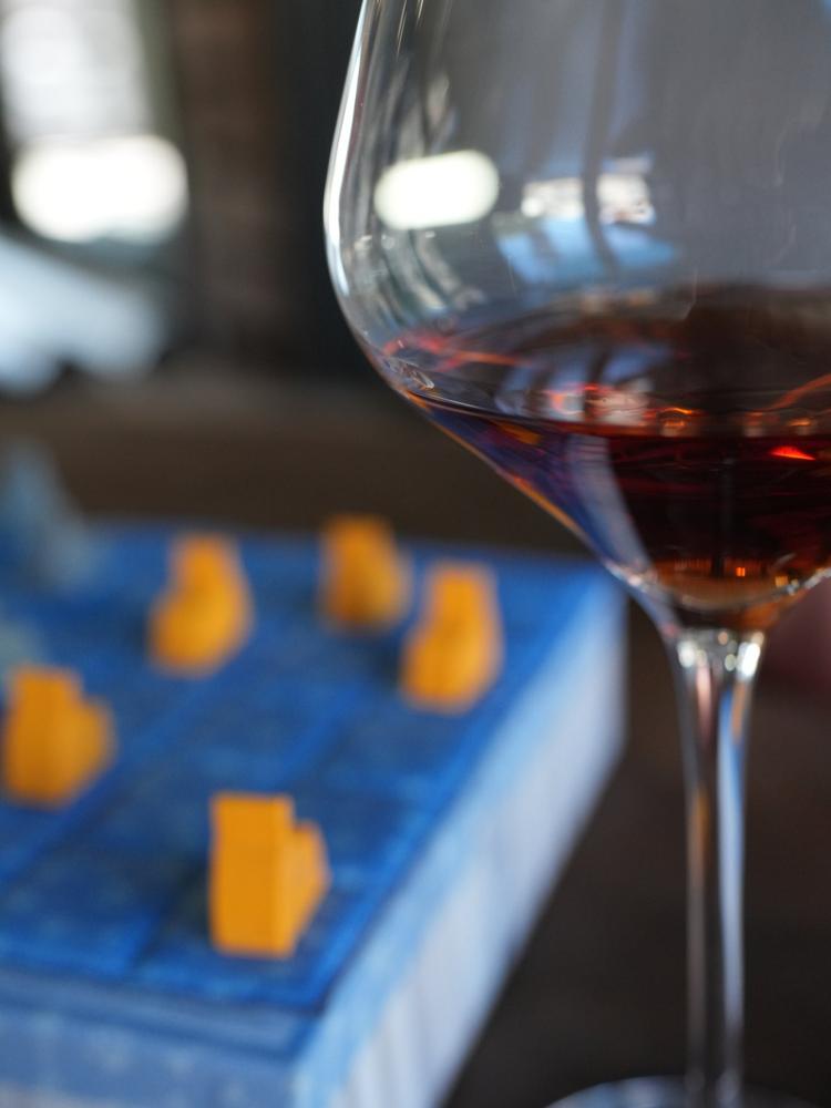 A board game and a glass of wine