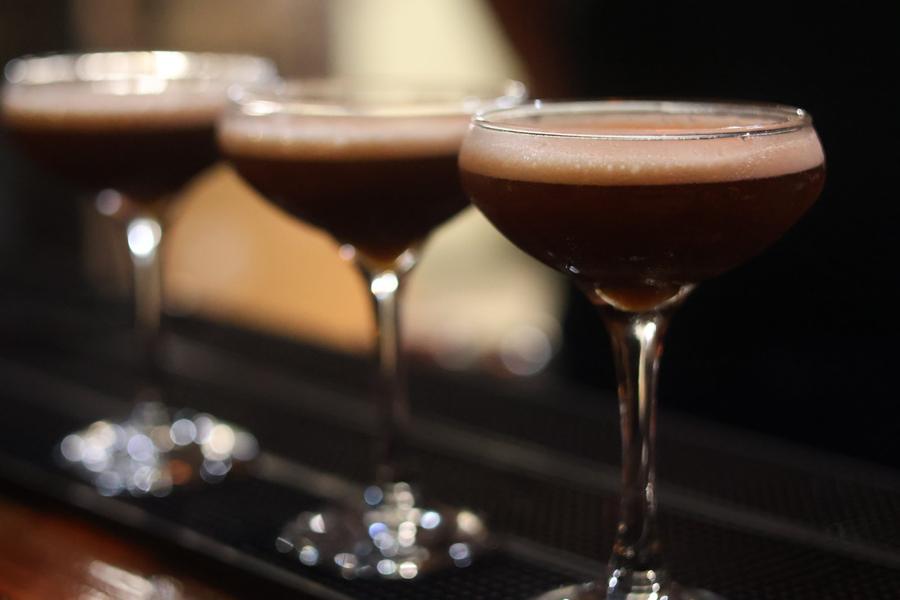 Three cocktails lined up on the bar