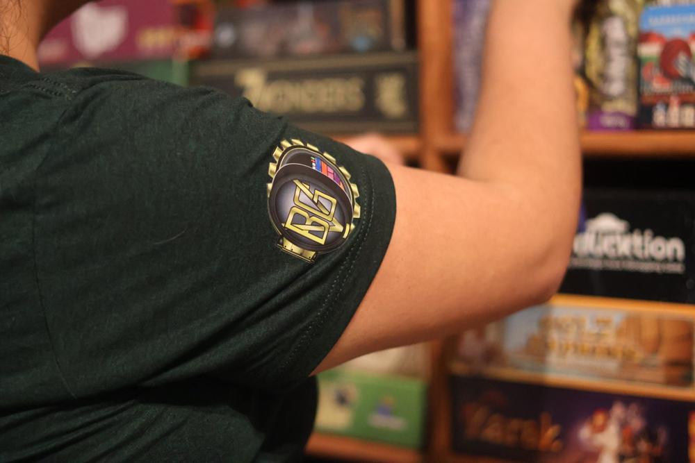 A Vault team shirt by the game shelves